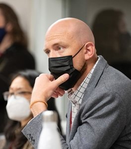 man listening wearing a mask