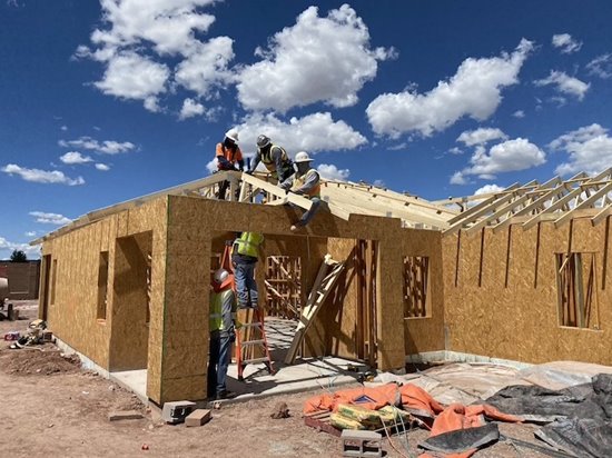 A home under construction against an amazing blue sky.