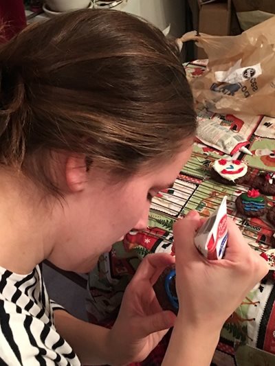 A volunteer practices one of the make and take projects at the community action center.