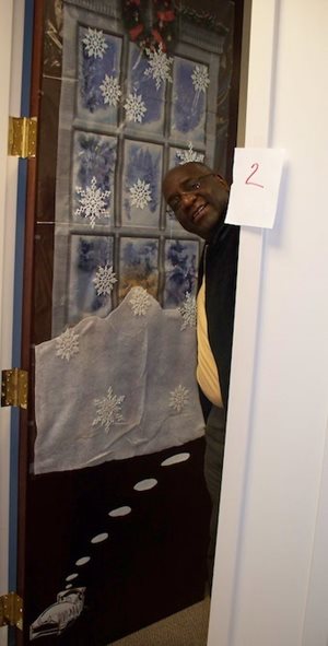 A staff member shows off a decorated door.