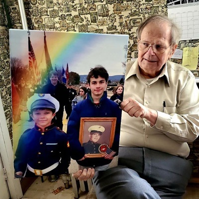 A grandfather holds a portrait of his grandchildren