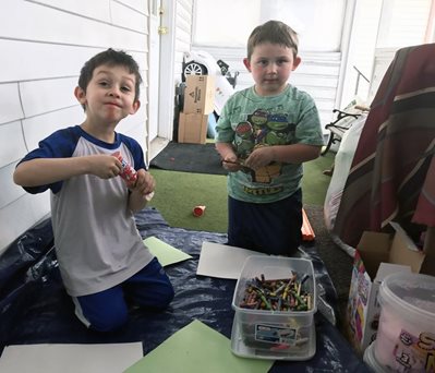 Two kids make care cards for their grandmother