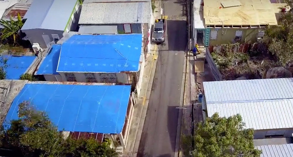 Tarps cover rooftops in Puerto Rico.