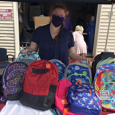 Backpacks for kids, arranged in an inviting rainbow of colors.