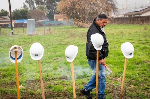 A member of the Tule tribe blesses the ground.