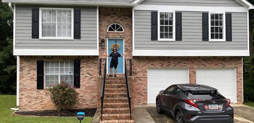 Kat Aristyl in front of her home.