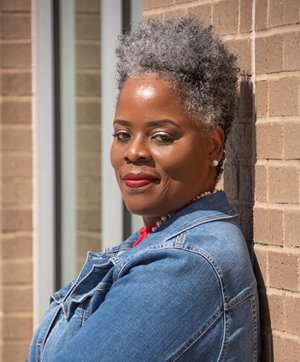 Tia McCoy smiles at the camera.