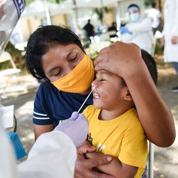 A child gets a COVID test, set up by The Unity Council