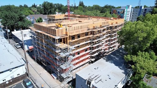 Lavender Courtyard is shown under construction, with a crane in the background.