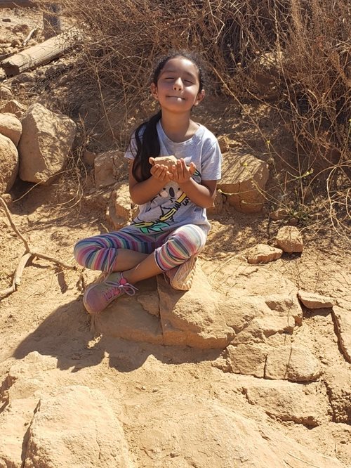 Isabella, a member of CHW's afterschool program, meditates at the top of the mountain.