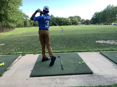 Better Family Life Golf: A player watches the ball fly after a swing.