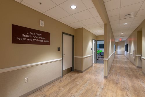 The health suite at the ground floor of J. Van Story Branch Apartments is open. Photo shows the entrance to the suite with a sign.