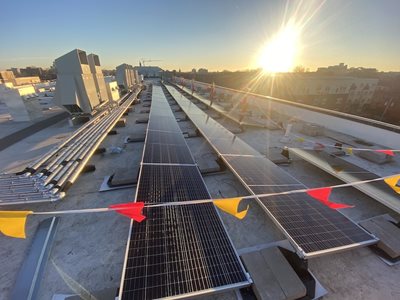 A solar array sits on top of an Aeon apartment building.