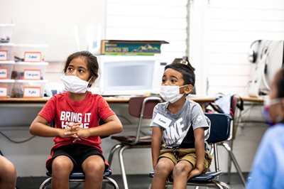 Students learn to sit and be in a group.