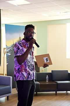 Brandon holds the microphone at one of his community gatherings.