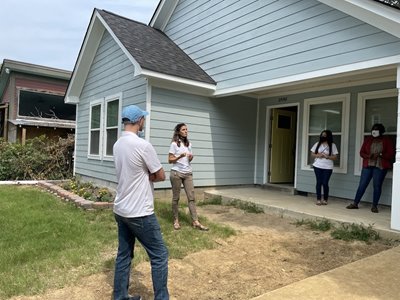 United Housing staff stand outside the home of Flor del Rocio Cordova -Puente.