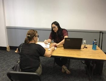 A community health worker listens to a client.