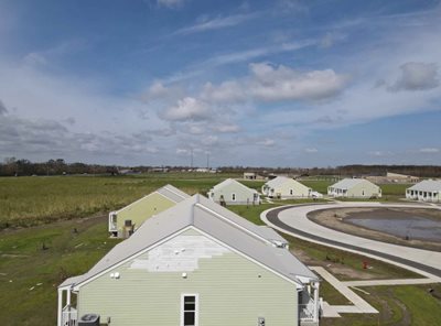 Hurricane proof housing on the Gulf Coast shows the duplexes and triplexes under a sunny sky.