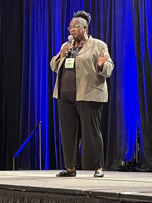 J'Tanya speaking in front of an audience.