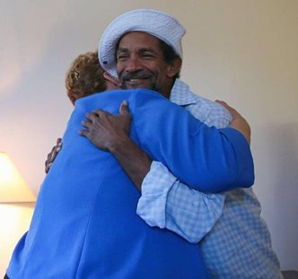 Martha Kegel hugs a newly housed veteran