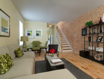 A furnished living room inside a row house.