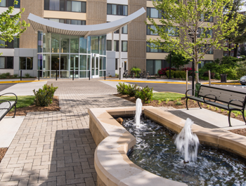 Edgewood's newly revitalized apartment complex with a fountain and landscaped park