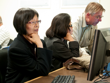 Senior woman looking at a computer.