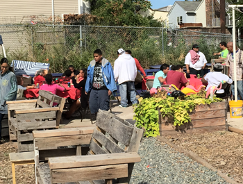 Residents revitalize a vacant lot, adding benches, a garden and a stage