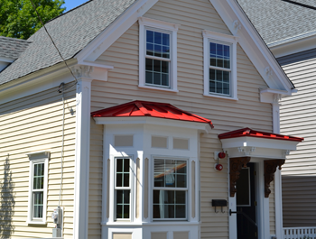 A beige house with red trim