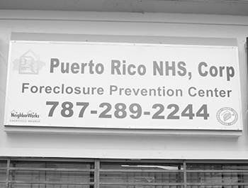 A sign on a building that says Puerto Rico NHS Corp Foreclosure Prevention Center