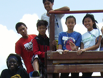 A diverse group of kids stand on a new playground