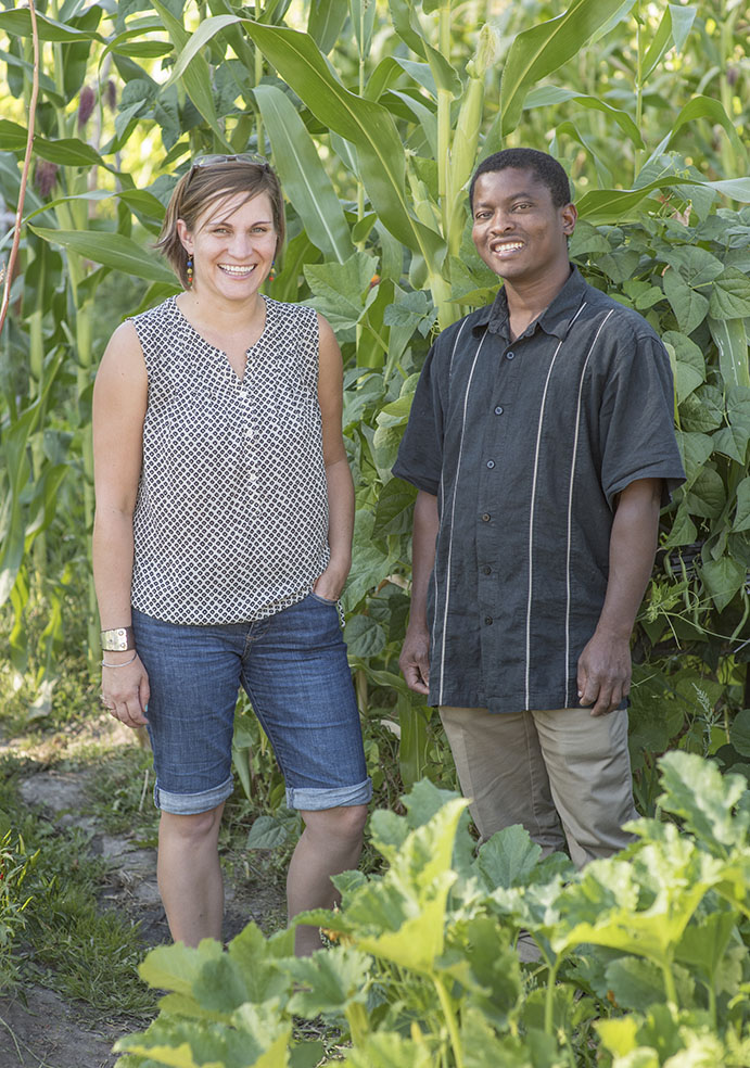 Erin Sorensen stands with a man in the community garden